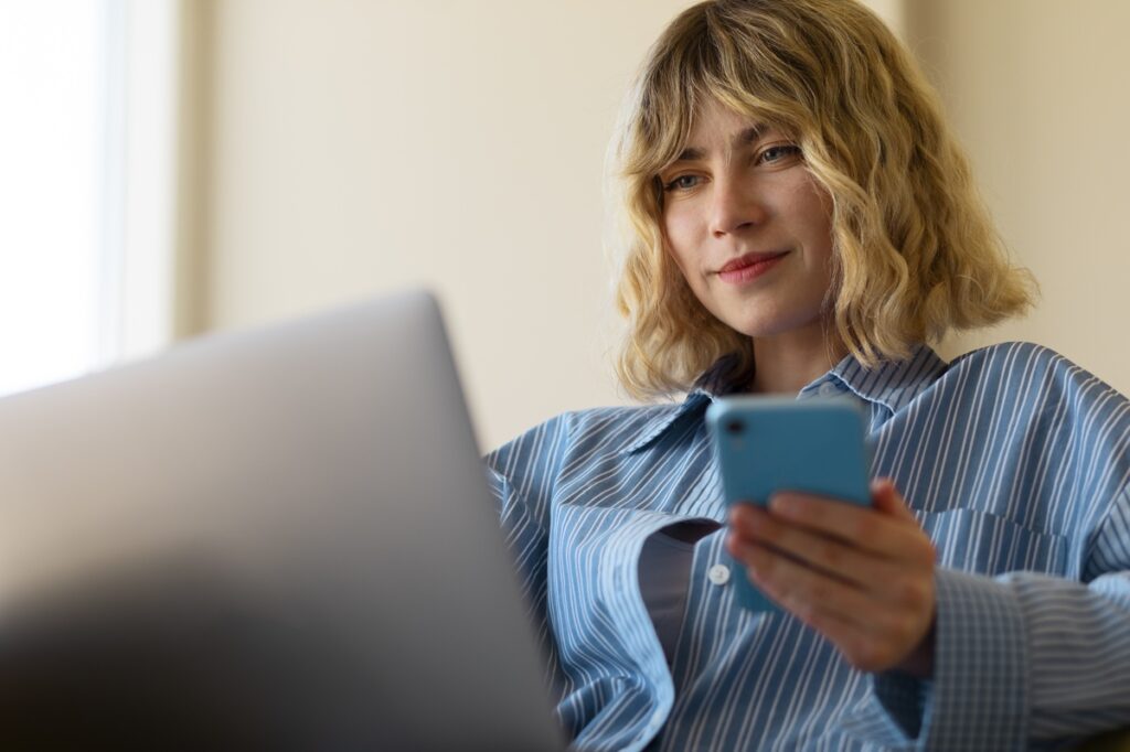 Side view woman holding smartphone