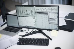 A professional computer monitor displaying complex data charts and analytics, representing a marketing audit.