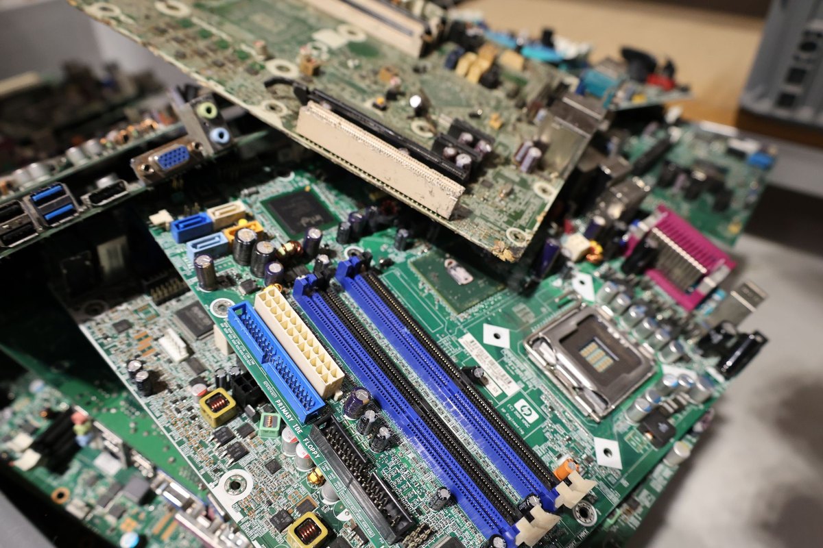 What Really Happens to the Data Center Gear Nobody Will Buy A cluttered pile of decommissioned circuit boards and IT hardware, representing the end of the data center lifecycle.